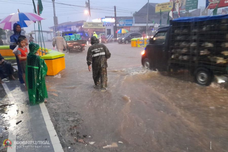 Jalan Terendam Banjir, Babinsa Lebaksiu Kodim 0712 Tegal Bantu Atur Lalu Lintas